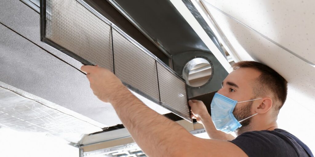 Male Technician Cleaning - Benefits Of Zoning Systems For Heating And Cooling